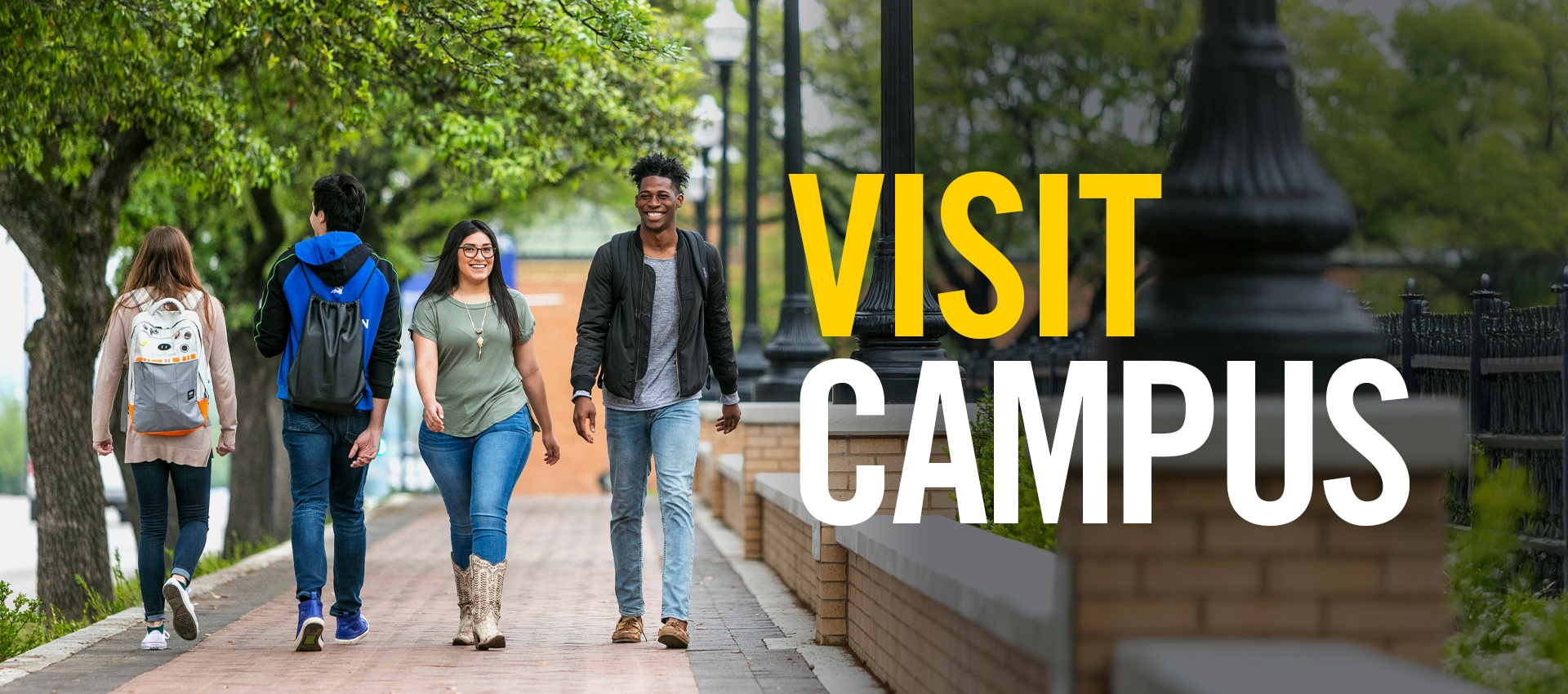 Students Walking on the sidewalk in front of campus.